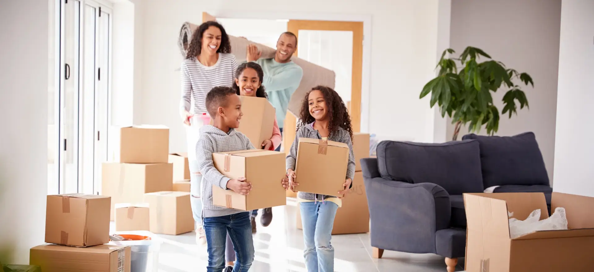 Happy family moving in to their new home thanks to Number 1 Lending